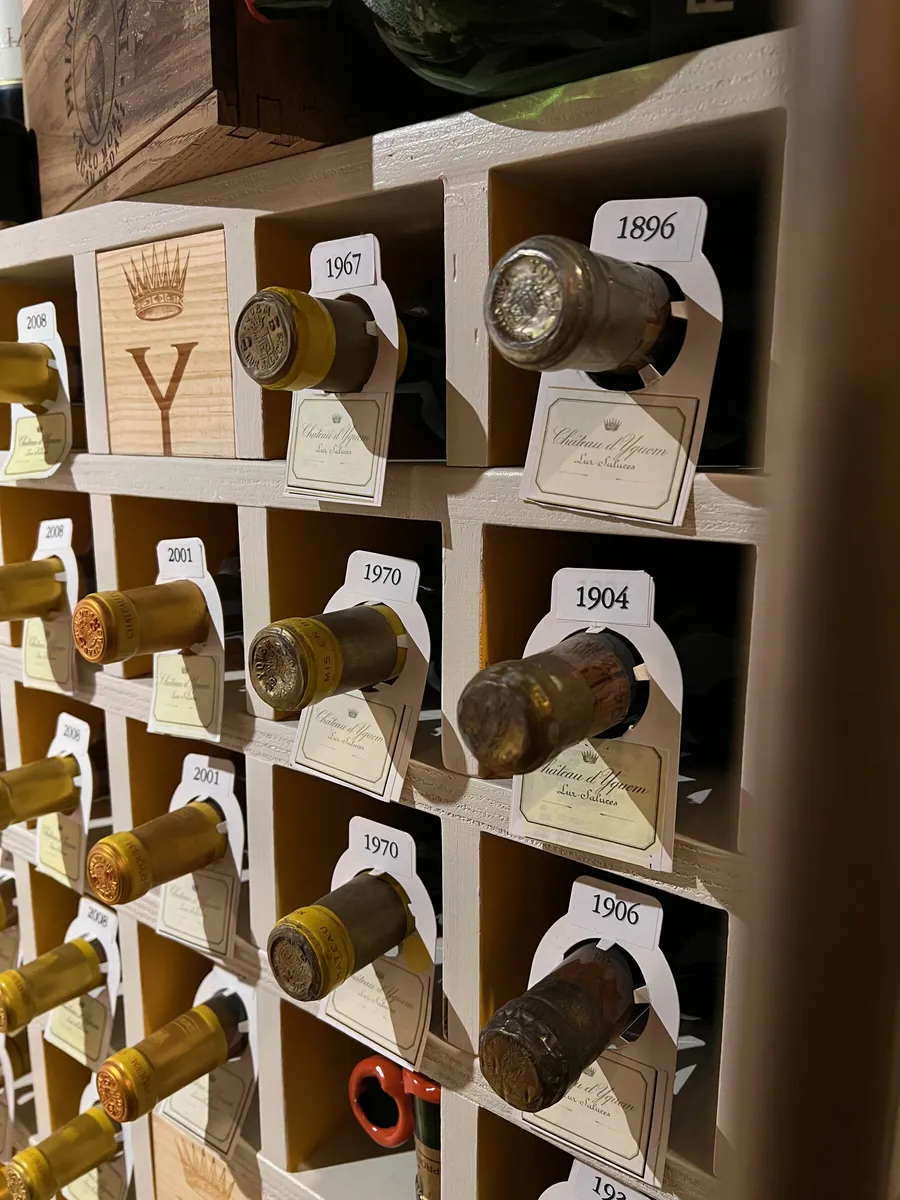 Old bottles from 1896 and 1904 in a cellar rack